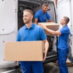 Truck Movers Loading Van Carrying Boxes And Moving House